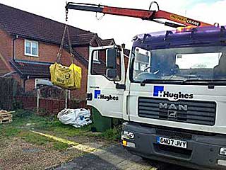 crane lifting grab bag into position in the gosport area